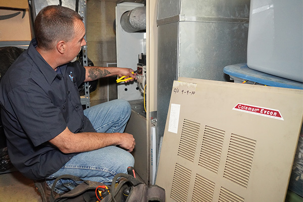 Gas furnace being serviced by a Modern Comfort heating technician